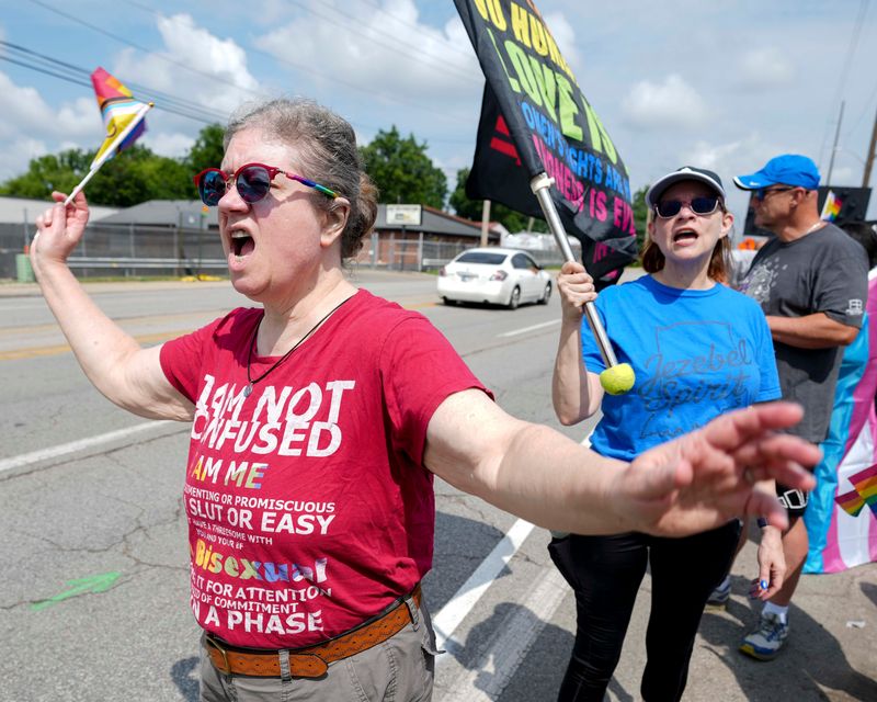 Amy Garrison yells to passing cars during a protest Sunday, July 13, 2025, outside Sure Foundation Baptist Church near Lafayette Road and West 30th Street in Indianapolis. Supporters of the LGBTQ+ community gathered to protest after a sermon was delivered at the church encouraging the deaths of those who identify as LGBTQ+. “Jesus would not approve of this, ever,” Garrison said.