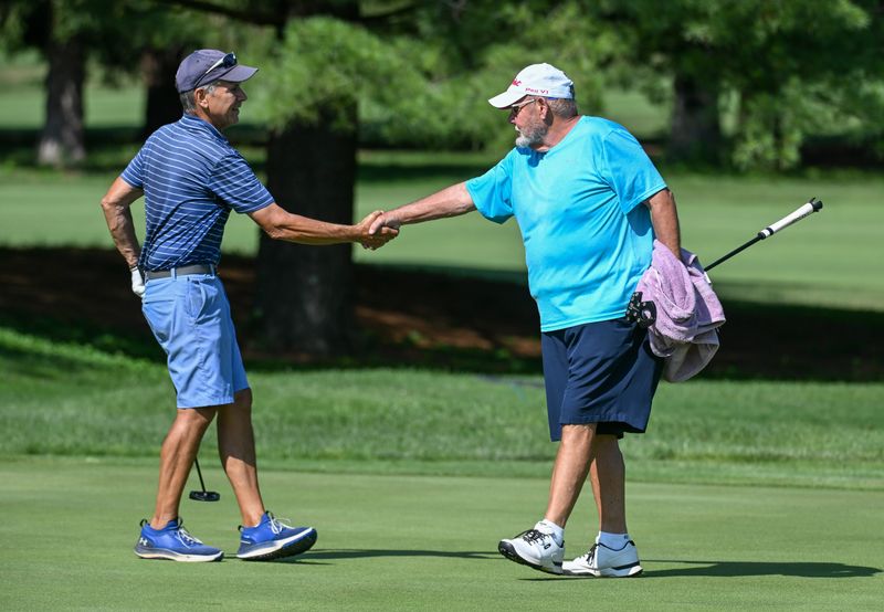 Dan Neubecker and Ike Martin shake hands after Martin’s 2 and 1 win in the Super Senior Championship division in the City Golf Tournament at Cascades Golf Course on Sunday, July 13, 2025.