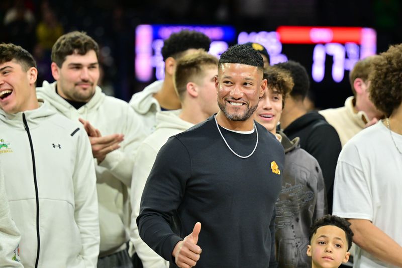 Feb 19, 2025; South Bend, Indiana, USA; Notre Dame head football coach Marcus Freeman and team are honored in the first half of the game between the Notre Dame Fighting Irish and the SMU Mustangs at the Purcell Pavilion. Mandatory Credit: Matt Cashore-Imagn Images
