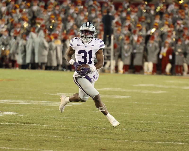 Nov 30, 2024; Ames, Iowa, USA; Kansas State Wildcats running back DJ Giddens (31) runs for a first down against the Iowa State Cyclones in the second quarter at at Jack Trice Stadium. Mandatory Credit: Reese Strickland-Imagn Images