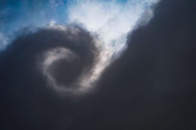 Storm clouds and rain skirt the edge of the Indianapolis International Airport on Thursday, July 17, 2025, in Indianapolis.