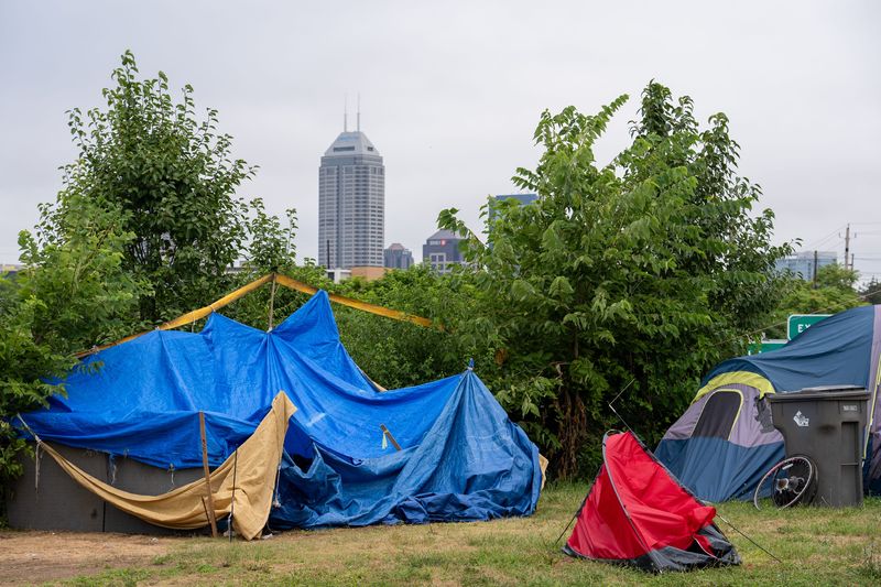 Trash sits out Friday, July 18, 2025, near a homeless camp off Leonard Street in the Fountain Square area of Indianapolis.