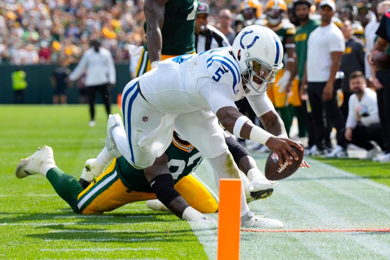 Sep 15, 2024; Green Bay, Wisconsin, USA; Indianapolis Colts quarterback Anthony Richardson (5) dives to earn a first down during the fourth quarter against the Green Bay Packers at Lambeau Field. Mandatory Credit: Jeff Hanisch-Imagn Images