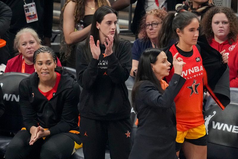 Indiana Fever's Caitlin Clark (22) watches the action on the court from the bench Saturday, July 19, 2025, during the WNBA All-Star Game at Gainbridge Fieldhouse in Indianapolis.