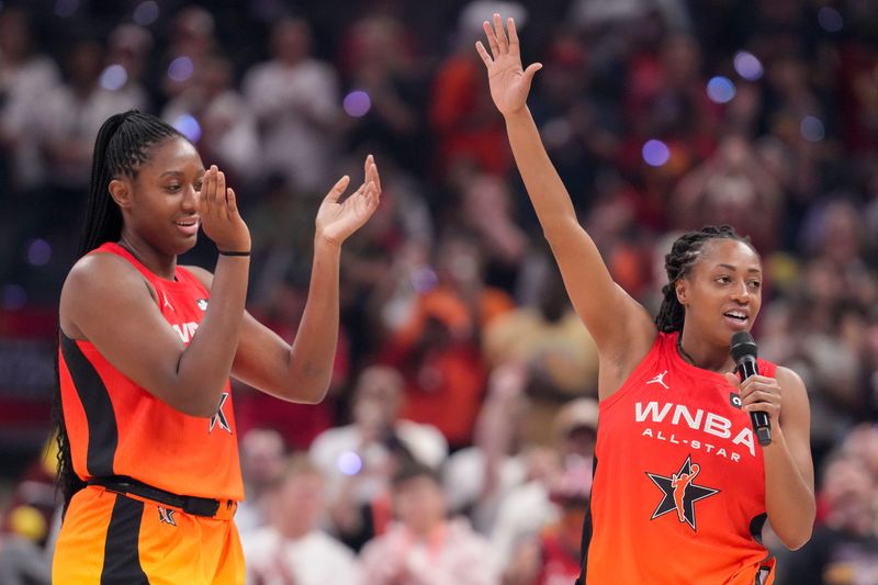 Indiana Fever's Aliyah Boston (7) claps as Indiana Fever's Kelsey Mitchell (0) addresses the crowd Saturday, July 19, 2025, during the WNBA All-Star Game at Gainbridge Fieldhouse in Indianapolis.