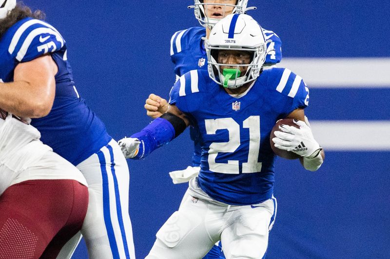 Oct 30, 2022; Indianapolis, Indiana, USA; Indianapolis Colts running back Nyheim Hines (21) runs the ball in the second quarter against the Washington Commanders at Lucas Oil Stadium. Mandatory Credit: Trevor Ruszkowski-USA TODAY Sports