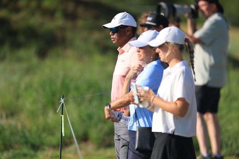 Tiger Woods watches son, Charlie Woods, tee off on the first hole during the second round of stroke play of the 2025 U.S. Junior Amateur at Trinity Forest Golf Club in Dallas, Texas on Tuesday, July 22, 2025. (Dustin Satloff/USGA)
