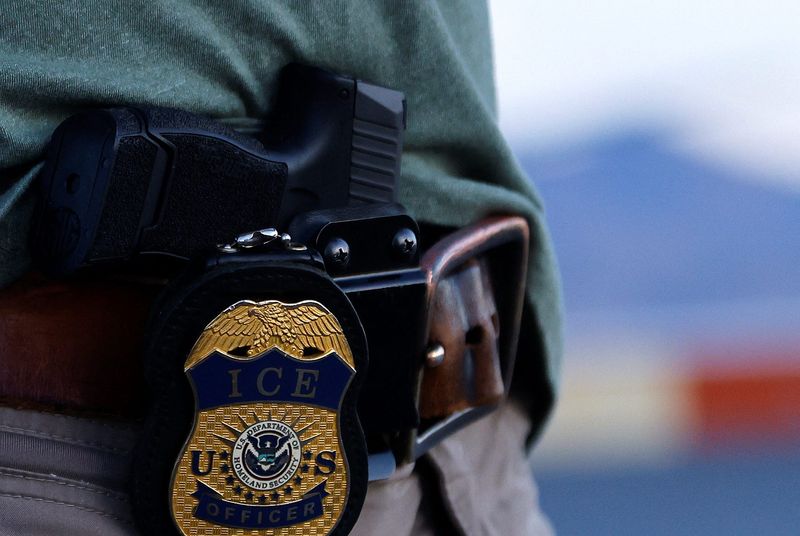 The badge of a U.S. Immigration and Customs Enforcement (ICE) agent is seen at the airport in El Paso, Texas, U.S., May 10, 2023.