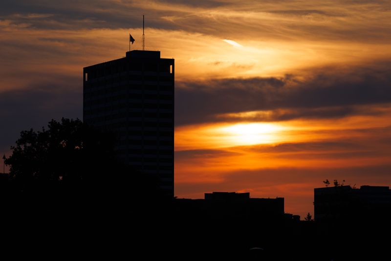The sun sets behind Liberty Tower on Monday, July 21, 2025, in South Bend.