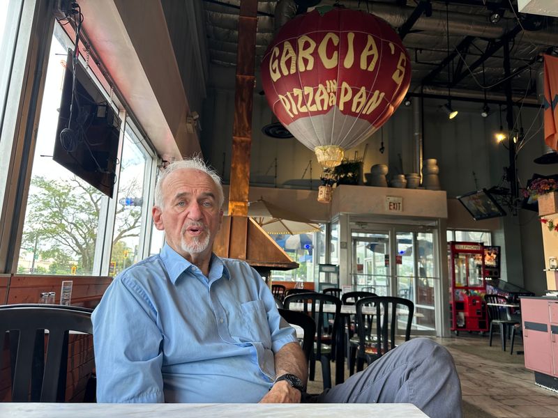 Ralph Senn, co-owner of Garcia's Pizza In A Pan, sits at a table inside the Champaign, Illinois, store. The pizza-by-slice store operated in West Lafayette from the early 1980s to the mid-1990s.