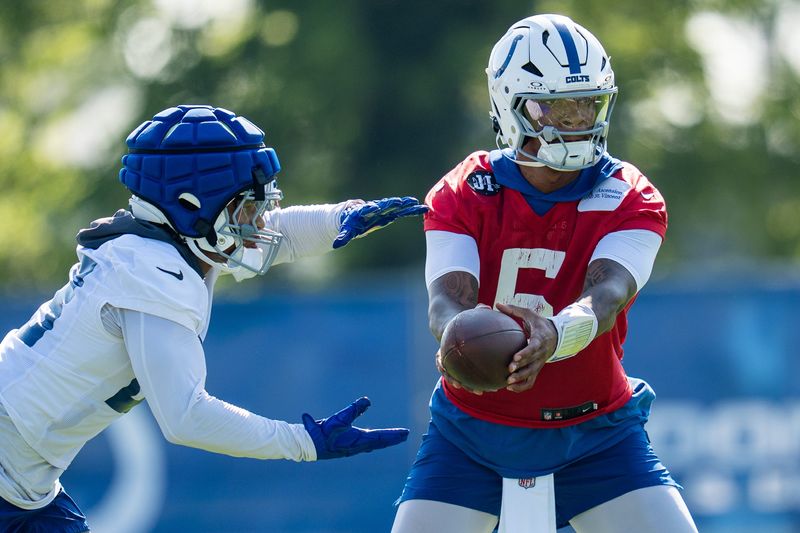 Indianapolis Colts quarterback Anthony Richardson Sr. (5) hands off to running back Jonathan Taylor (28) on Wednesday, July 23, 2025, during the first day of training camp held at Grand Park in Westfield.