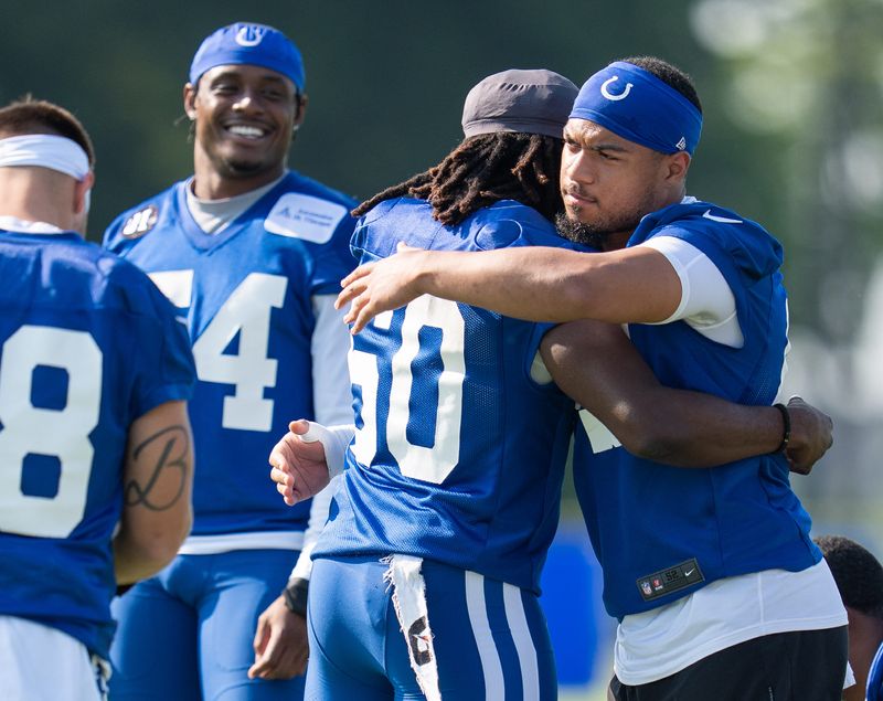 Indianapolis Colts linebacker Cameron McGrone (59) gives a hug to fellow linebacker Segun Olubi (50) on Thursday, July 24, 2025, ahead of training camp held at Grand Park in Westfield.