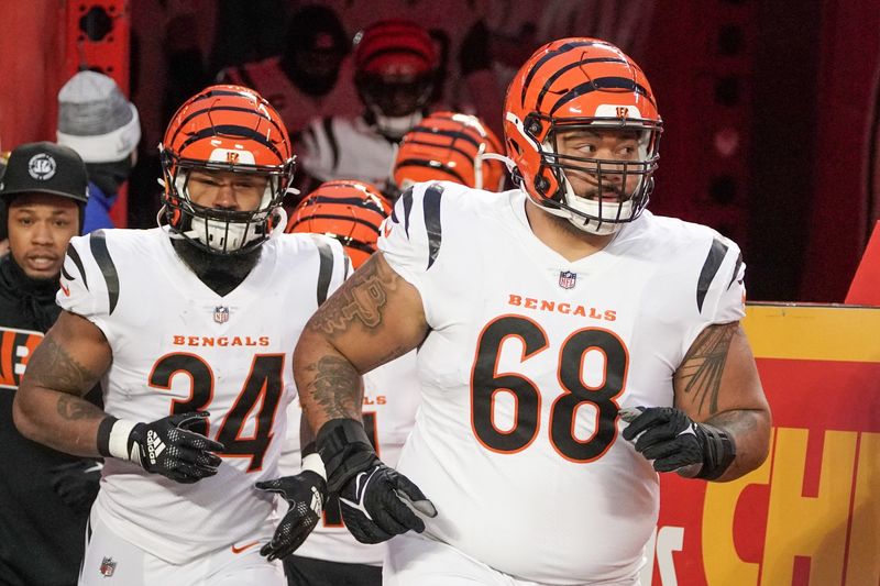 Jan 29, 2023; Kansas City, Missouri, USA; Cincinnati Bengals defensive tackle Josh Tupou (68) and running back Samaje Perine (34) take the field against the Kansas City Chiefs prior to the AFC Championship game at GEHA Field at Arrowhead Stadium. Mandatory Credit: Denny Medley-USA TODAY Sports