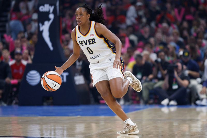 Jul 27, 2025; Chicago, Illinois, USA; Indiana Fever guard Kelsey Mitchell (0) brings the ball up court against the Chicago Sky during the first half at United Center. Mandatory Credit: Kamil Krzaczynski-Imagn Images