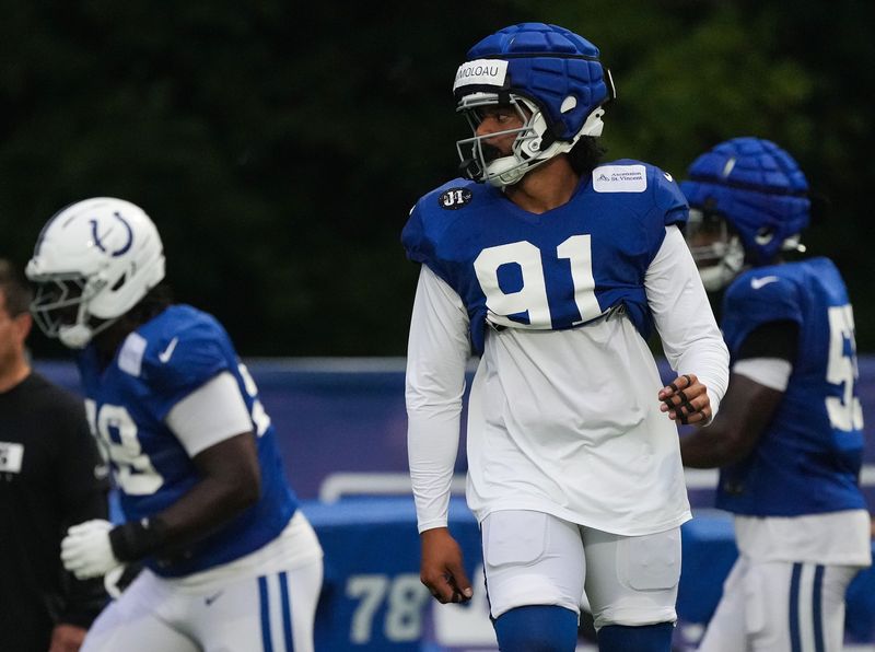 Indianapolis Colts defensive end JT Tuimoloau (91) walks up the field Thursday, July 31, 2025, during Colts Training Camp at Grand Park in Westfield.