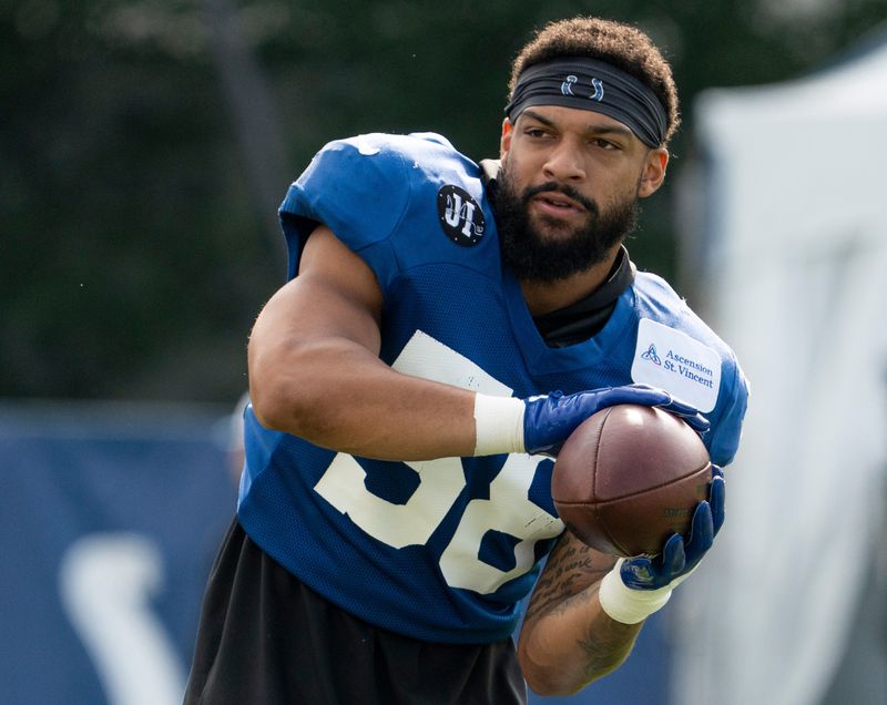Indianapolis Colts linebacker Austin Ajiake (58) catches a ball Saturday, Aug. 2, 2025, before Colts camp at Grand Park in Westfield.