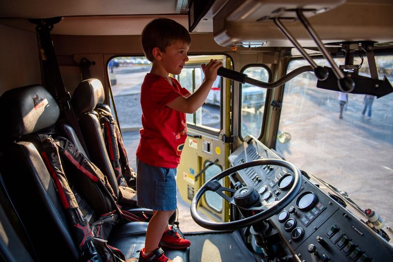 Lincoln Hahn operates the turret on the fire truck from the Evansville Regional Airport during National Night Out at the CK Newsome Center in Evansville, Ind., Tuesday, August 5, 2025.
