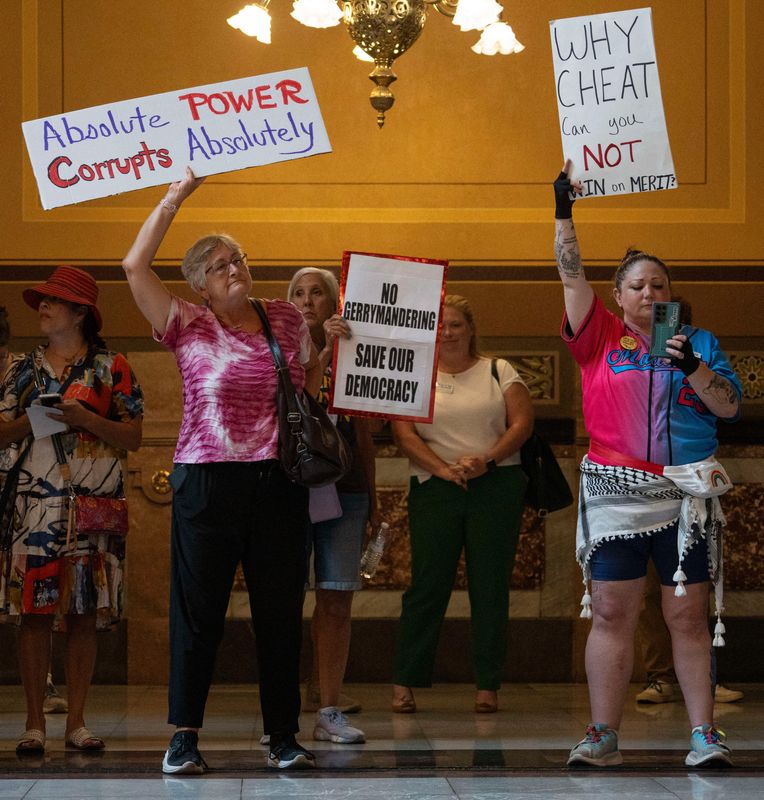Citizens display homemade signs on Thursday, Aug. 7, 2025, for the Statehouse Sit-In: No Cheaters in Democracy in Indianapolis in the Indianapolis Statehouse
