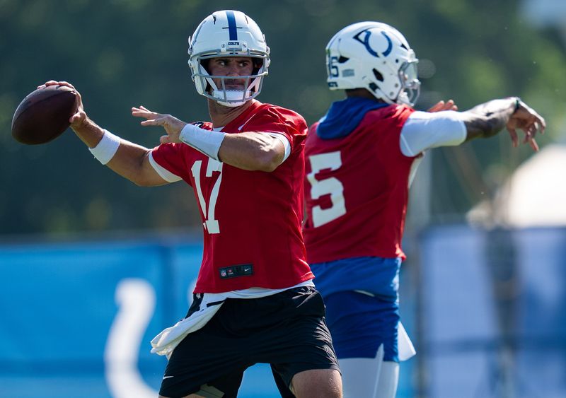 Indianapolis Colts quarterbacks Anthony Richardson Sr. (5) and Daniel Jones (17) pass Wednesday, July 23, 2025, during the first day of training camp held at Grand Park in Westfield.