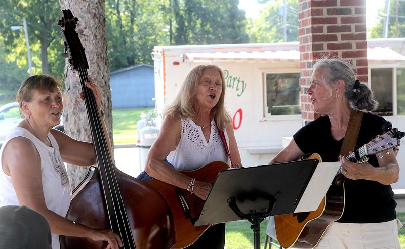 Creekside Band members, from left, are Carolyn Hodges, Becky Sprinkle and Debbie Porter. The group performed Thursday, Aug. 7, 2025, in the Orleans Town Square Park gazebo during Food Truck Frenzy. The three, along with five others, comprise the Creekside Band and Friends. Sprinkle said, "This is the first time we have really gotten to play here. It's been rained out several times." The group plays traditional mountain music, known to many as bluegrass.