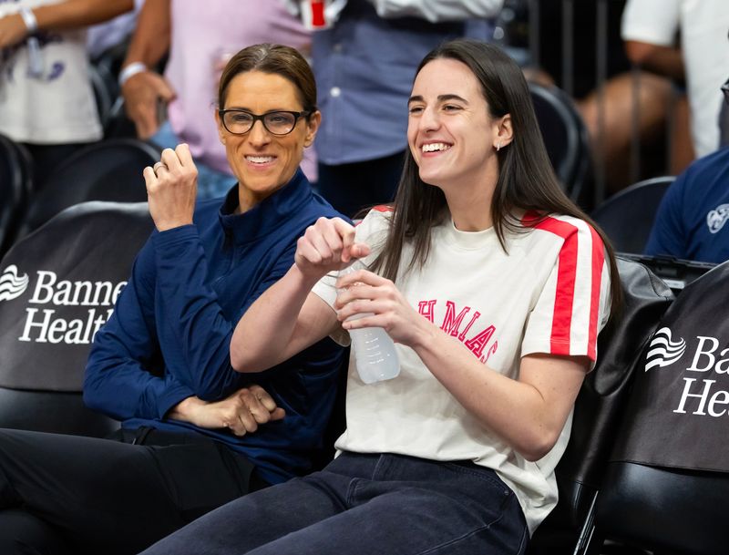 Aug 7, 2025; Phoenix, Arizona, USA; Indiana Fever injured guard Caitlin Clark (right) with head coach Stephanie White against the Phoenix Mercury during an WNBA game at PHX Arena. Mandatory Credit: Mark J. Rebilas-Imagn Images