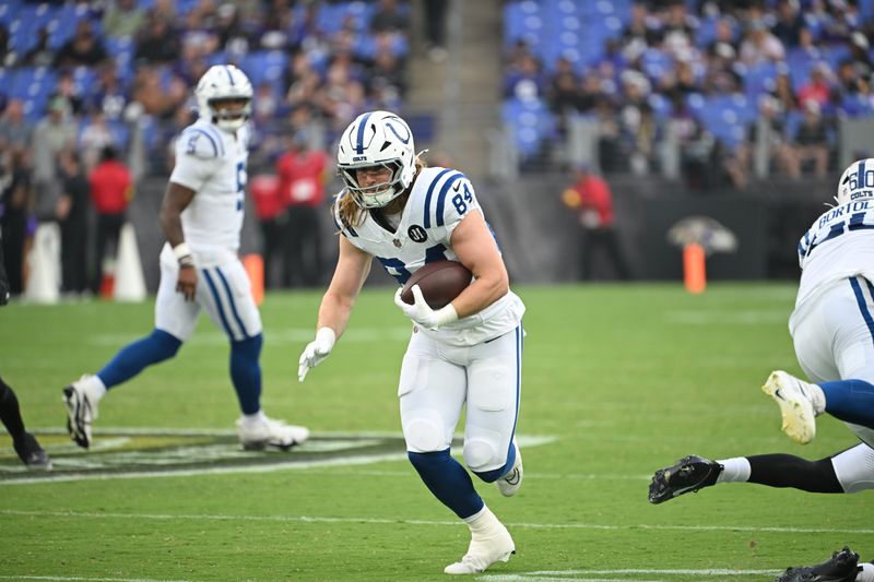Aug 7, 2025; Baltimore, Maryland, USA; Indianapolis Colts tight end Tyler Warren (84) runs with the ball after making a catch against the Baltimore Ravens during the first quarter at M&T Bank Stadium. Mandatory Credit: Rafael Suanes-Imagn Images