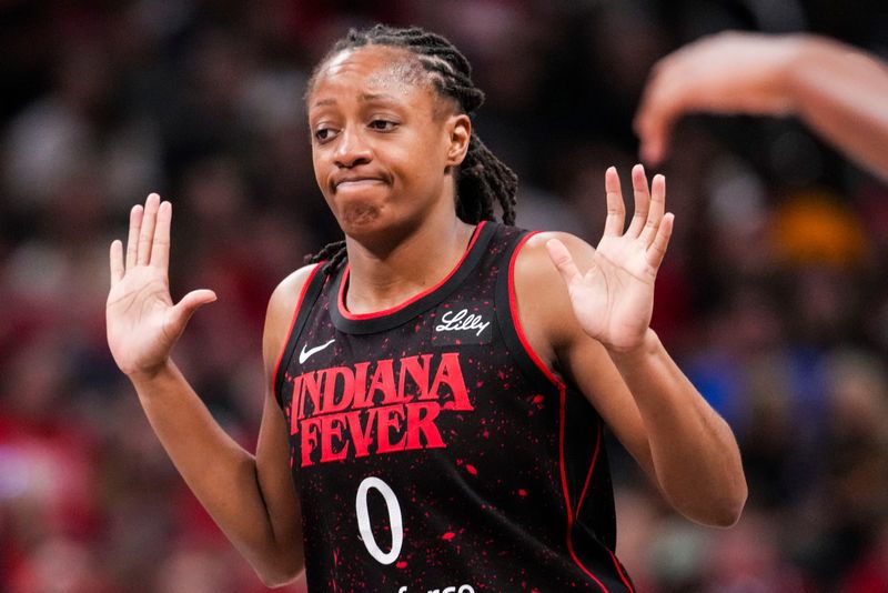 Indiana Fever guard Kelsey Mitchell (0) reacts to a call Saturday, Aug. 9, 2025, during a game between the Indiana Fever and the Chicago Sky at Gainbridge Fieldhouse in Indianapolis.