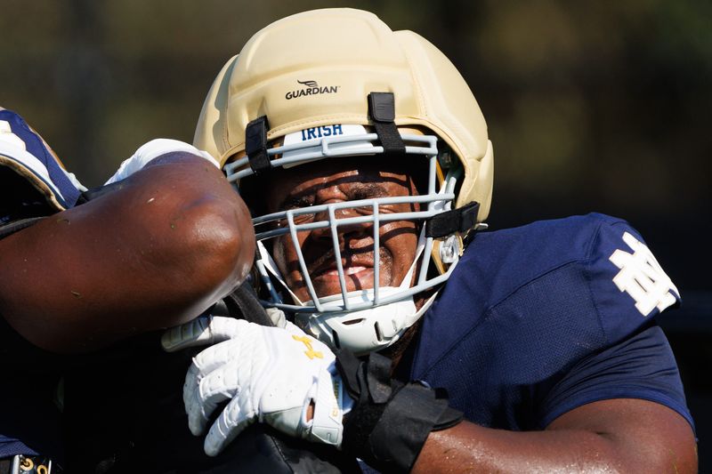 Notre Dame offensive lineman Aamil Wagner hits a bag during a football practice at Irish Athletic Center on Sunday, Aug. 10, 2025, in South Bend.