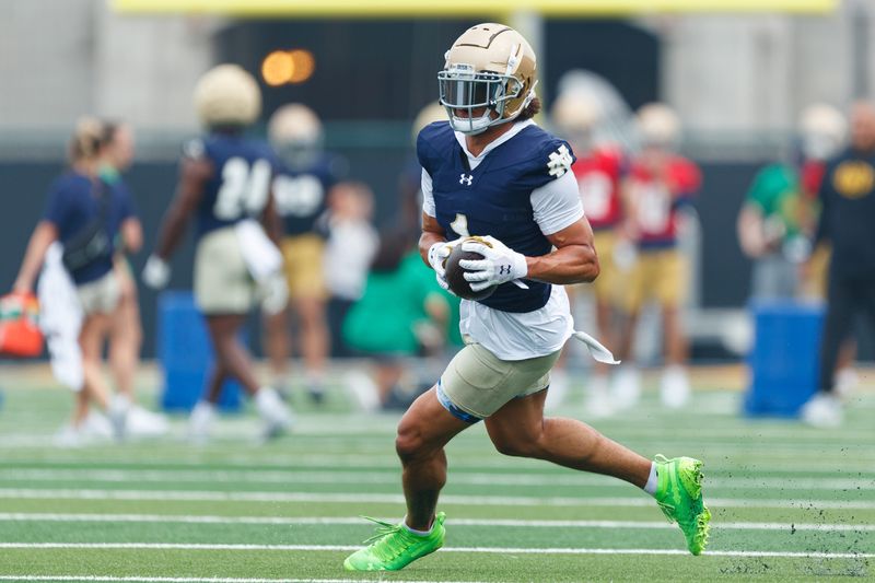 Notre Dame wide receiver Jaden Greathouse runs with the ball during a football practice at Irish Athletic Center on Thursday, July 31, 2025, in South Bend.