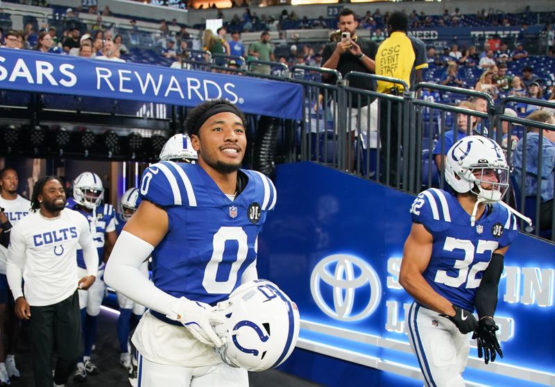 Aug 16, 2025; Indianapolis, Indiana, USA; Indianapolis Colts safety Cam Bynum (0) and Indianapolis Colts safety Daniel Scott (32) run onto the field during warmups prior to the game agains the Green Bay Packers at Lucas Oil Stadium. Mandatory Credit: Robert Goddin-Imagn Images