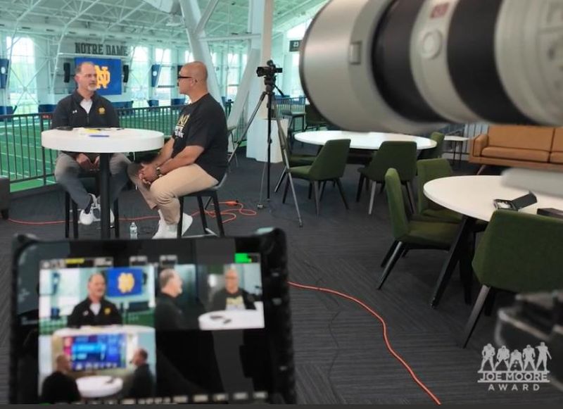 Notre Dame football offensive line great Aaron Taylor interviews Irish offensive line coach Joe Rudolph for an upcoming segment of 'Trench Life,' a weekly YouTube podcast launched in connection with the Joe Moore Award