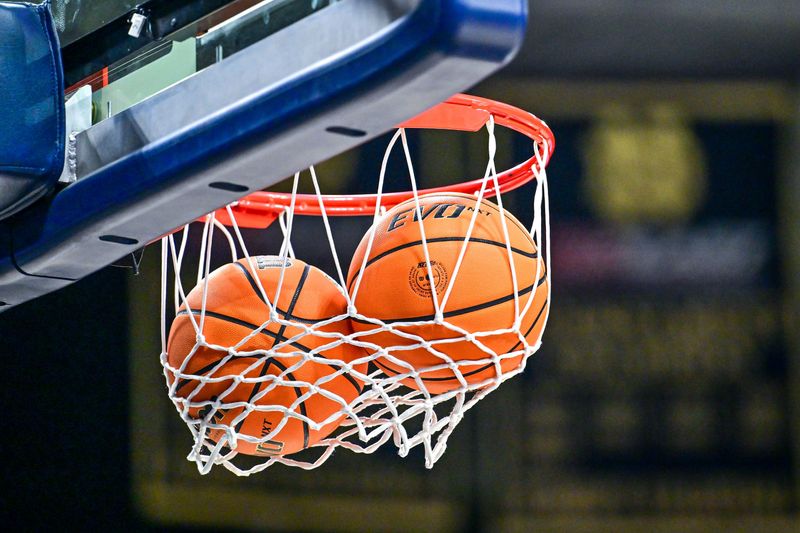Dec 7, 2024; South Bend, Indiana, USA; Two basketballs are stuck in the net before the start of the second half of the game between the Notre Dame Fighting Irish and the Syracuse Orange at the Purcell Pavilion. Mandatory Credit: Matt Cashore-Imagn Images