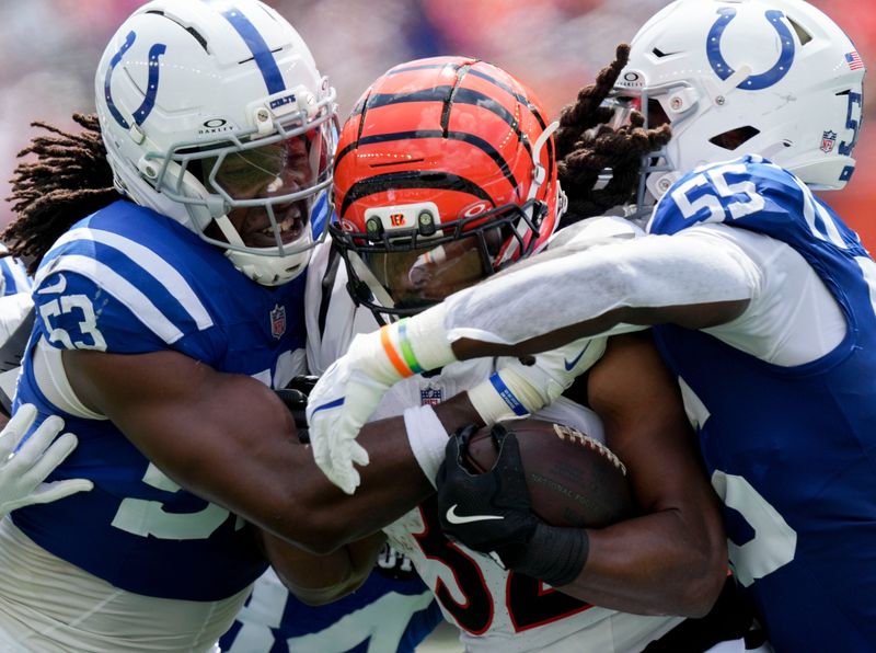Indianapolis Colts linebacker Solomon DeShields (53) and Indianapolis Colts defensive end Isaiah Land (55) work to bring down Cincinnati Bengals running back Gary Brightwell (32) on Saturday, Aug. 23, 2025, during a game against the Cincinnati Bengals at Paycor Stadium in Cincinnati.
