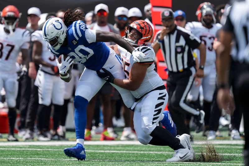 A Cincinnati Bengals defender works to bring down Indianapolis Colts tight end Jelani Woods (80) on Saturday, Aug. 23, 2025, during a game against the Cincinnati Bengals at Paycor Stadium in Cincinnati.
