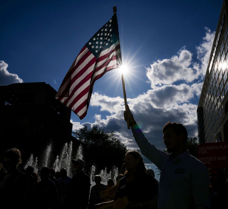 A flag is held up Tuesday, Aug. 26, 2025, during a rally against unfair redistricting efforts at the Indiana State Capitol in Indianapolis.