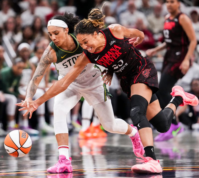 Seattle Storm forward Gabby Williams (5) and Indiana Fever guard Aerial Powers (23) go for the ball Tuesday, Aug. 26, 2025, during a game between the Indiana Fever and the Seattle Storm at Gainbridge Fieldhouse in Indianapolis. The Indiana Fever defeated the Seattle Storm, 95-75.
