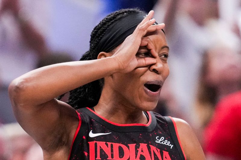 Indiana Fever guard Shey Peddy (5) celebrates Indiana Fever guard Odyssey Sims (1) on Tuesday, Aug. 26, 2025, during a game between the Indiana Fever and the Seattle Storm at Gainbridge Fieldhouse in Indianapolis. The Indiana Fever defeated the Seattle Storm, 95-75.