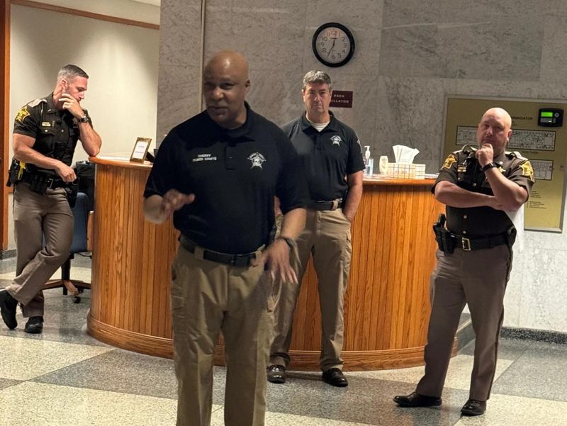 Monroe County Sheriff Ruben Marte in the justice center lobby explaining the inmate relocation plan to his staff.