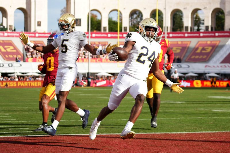 Nov 30, 2024; Los Angeles, California, USA; Notre Dame Fighting Irish running back Jadarian Price (24) scores on a 36-yard touchdown run against the Southern California Trojans in the second half at United Airlines Field at Los Angeles Memorial Coliseum. Mandatory Credit: Kirby Lee-Imagn Images
