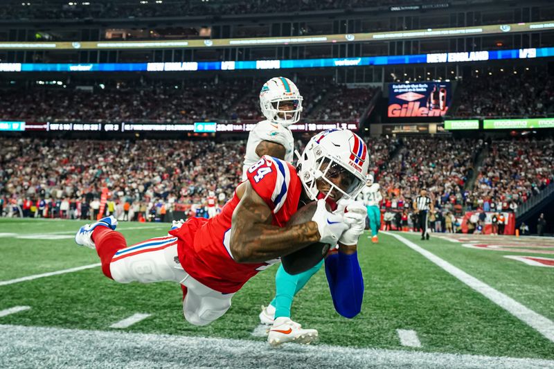 Sep 17, 2023; Foxborough, Massachusetts, USA; New England Patriots wide receiver Kendrick Bourne (84) called out of bounds with his catch against Miami Dolphins safety Jevon Holland (8) in the second half at Gillette Stadium. Mandatory Credit: David Butler II-USA TODAY Sports