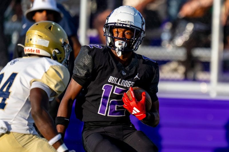 Brownsburg High School junior Branden Sharpe (12) works to avoid a Indianapolis Cathedral High School defender during the first half of an IHSAA varsity football game, Friday, Aug. 29, 2025, at Brownsburg High School.