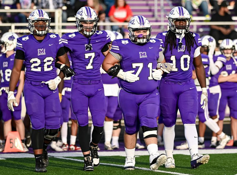 The Muncie Central captains take the field before an IHSAA high school football game against Yorktown Friday, Aug. 29, 2025, at Muncie Central High School.