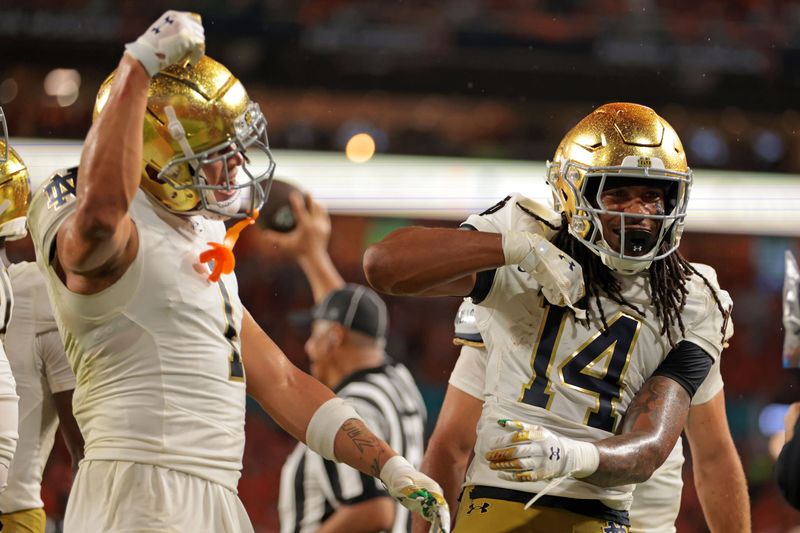 Aug 31, 2025; Miami Gardens, Florida, USA; Notre Dame Fighting Irish wide receiver Micah Gilbert (14) reacts after scoring a touchdown against the Miami Hurricanes during the second quarter at Hard Rock Stadium. Mandatory Credit: Sam Navarro-Imagn Images