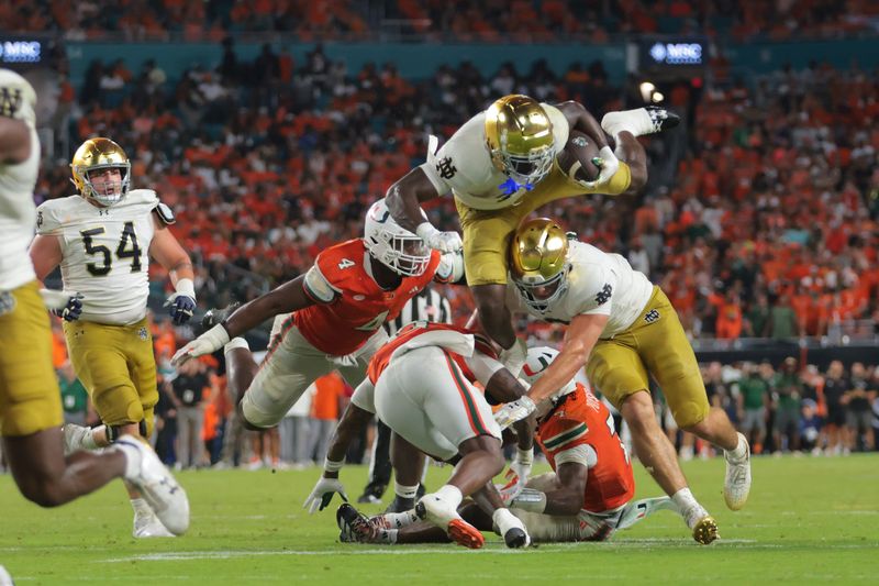 Aug 31, 2025; Miami Gardens, Florida, USA; Notre Dame Fighting Irish running back Jeremiyah Love (4) rushes the ball against the Miami Hurricanes during the third quarter at Hard Rock Stadium. Mandatory Credit: Sam Navarro-Imagn Images