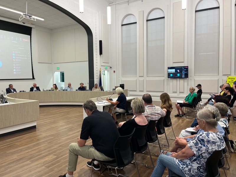 A woman gives public comment against the West Lafayette City Council's May rezoning of a site north of the city, where a semiconductor packaging plant will be built near neighborhoods.