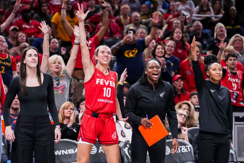 /Indiana Fever guard Caitlin Clark (22), Indiana Fever guard Lexie Hull (10), Indiana Fever assistant coach Karima Christmas-Kelly and Indiana Fever assistant coach Briann January celebrate Friday, Sept. 5, 2025, during a game between the Indiana Fever and the Chicago Sky at Gainbridge Fieldhouse in Indianapolis. The Indiana Fever defeated the Chicago Sky, 97-77.