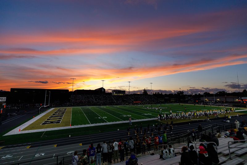 The sun sets on an IHSAA football game between Penn and Riley at Penn High School on Friday, Sept. 5, 2025, in Mishawaka.