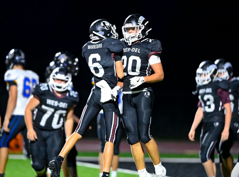 Wes-Del sophomores Noah Perdue (6) and Zach Gillam (20) celebrate during a high school football game against Blackhawk Christian Friday, Sept. 5, 2025, at Wes-Del High School in Gaston.