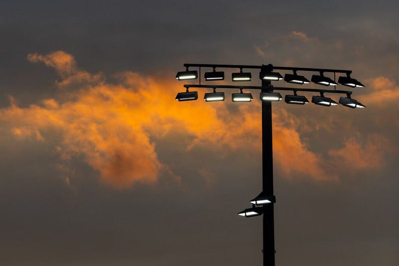 The sun sets near stadium lights during the Concord at Mishawaka High School football game Friday, Sept. 5, 2025.