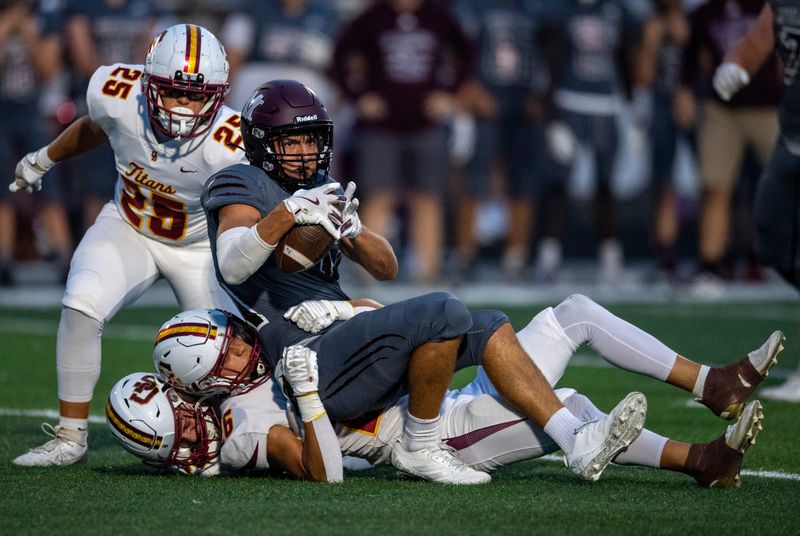Mount Vernon's Brady Schickel (11) is tackled as the Gibson Southern Titans play the Mount Vernon Wildcats Friday, Sept. 5, 2025.